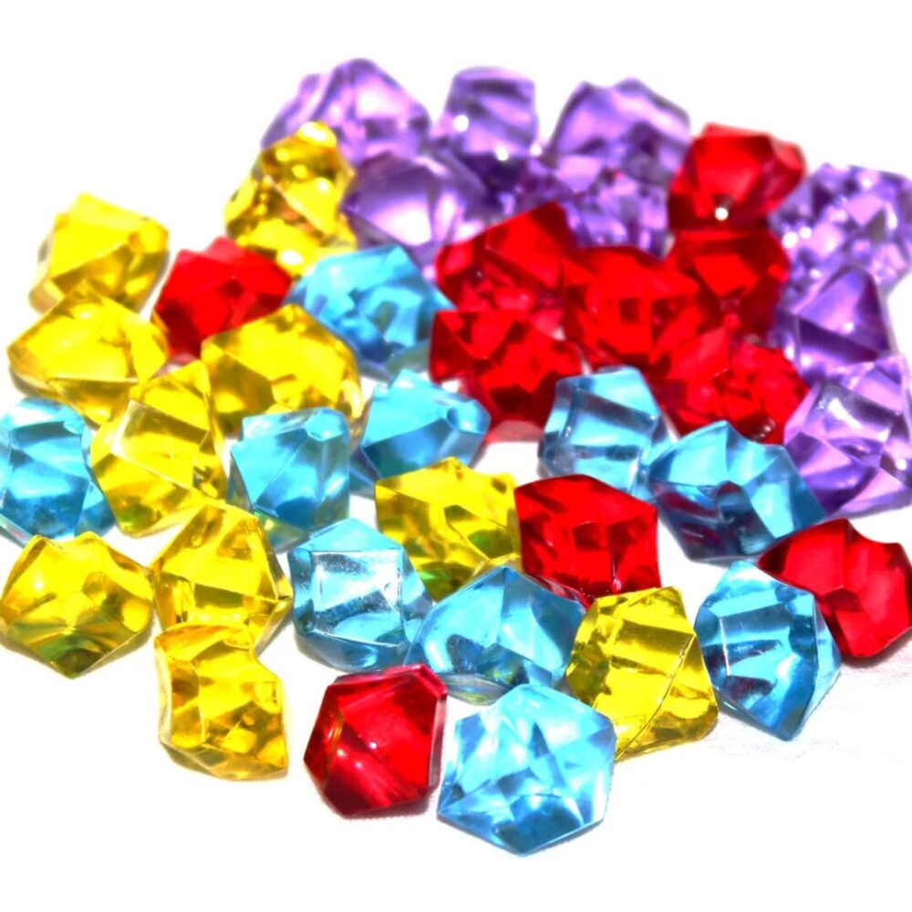 A colorful pile of small plastic crystal gem tokens from the game Trial of the Temples.